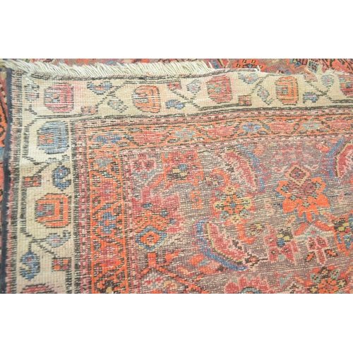 3121 - A Middle Eastern rectangular woollen carpet, the runner with a field of stylised flowers within guar... 