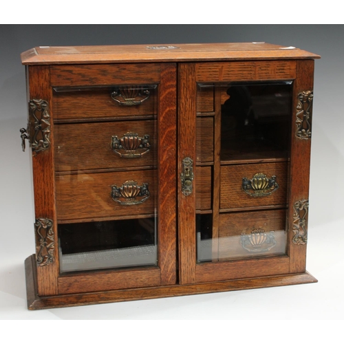 251 - An Arts & Crafts oak smoking companion cabinet, 50cm wide