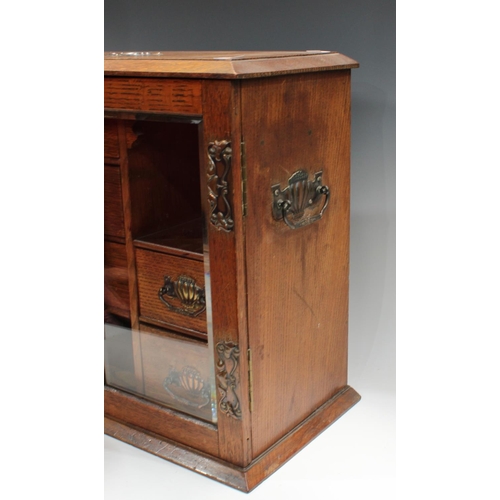 251 - An Arts & Crafts oak smoking companion cabinet, 50cm wide