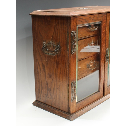 251 - An Arts & Crafts oak smoking companion cabinet, 50cm wide