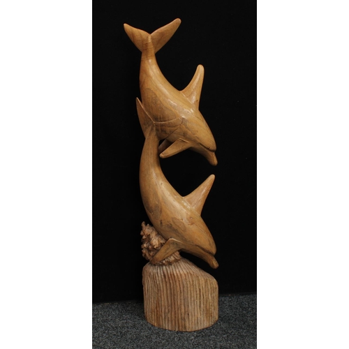 253 - A floor standing mango model, carved as a pair of dolphins, 104cm high