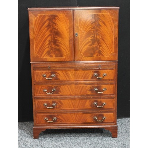 263 - A flame mahogany tall boy, with a pair of doors above a slide and four long drawers, possibly Maple ... 