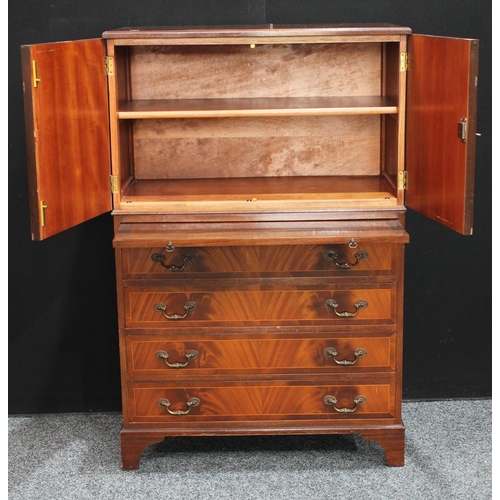 263 - A flame mahogany tall boy, with a pair of doors above a slide and four long drawers, possibly Maple ... 