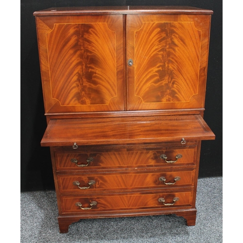 263 - A flame mahogany tall boy, with a pair of doors above a slide and four long drawers, possibly Maple ... 