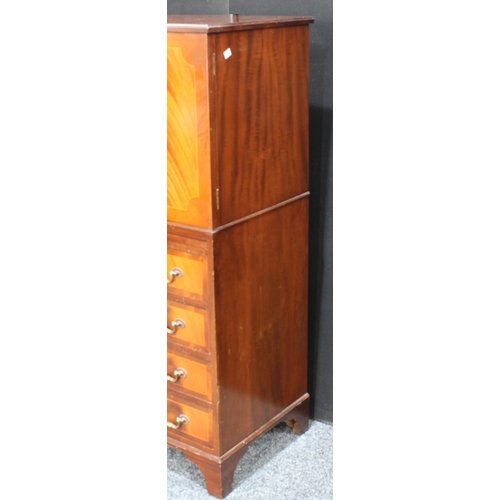 263 - A flame mahogany tall boy, with a pair of doors above a slide and four long drawers, possibly Maple ... 