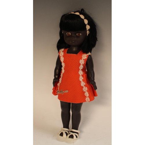 486 - A vintage 1950/60's black pedigree doll, soft head, sleeping eyes, hard body, jointed limbs, wearing... 