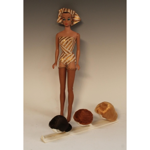 487 - A 1960s Fashion Queen Barbie doll, with original gold and white swim costume, Stocking, Scarf Hat an... 