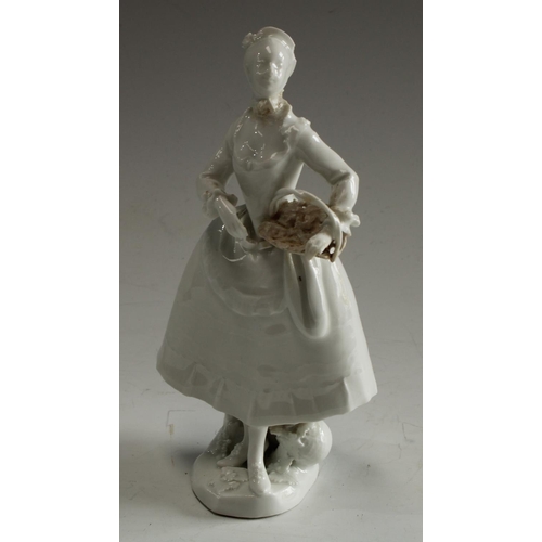 5031 - A Vienna figure, in the white, of a lady, holding a basket, 16cm high, Beehive mark