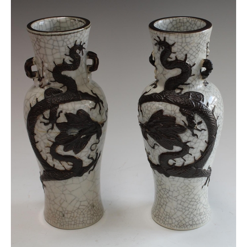 5122 - A pair of 20th century Chinese crackle glazed baluster vases, in relief in brown with scrolling drag... 