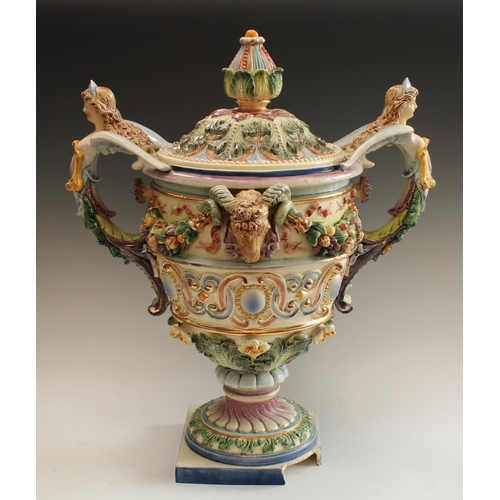 5124 - A large Italian two handled centrepiece in relief with ram's masks and fruit swags, caryaid handles,... 