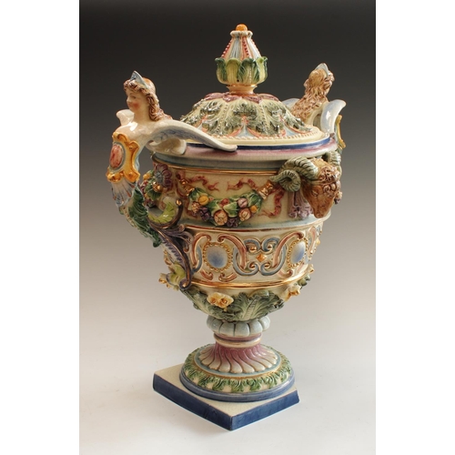 5124 - A large Italian two handled centrepiece in relief with ram's masks and fruit swags, caryaid handles,... 