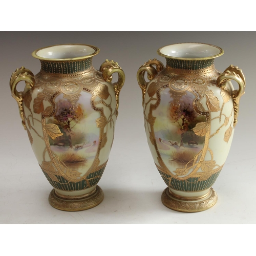 5126 - A pair of Noritake ovoid two handled vases, decorated with shield shped cartouches iwth cattle, the ... 
