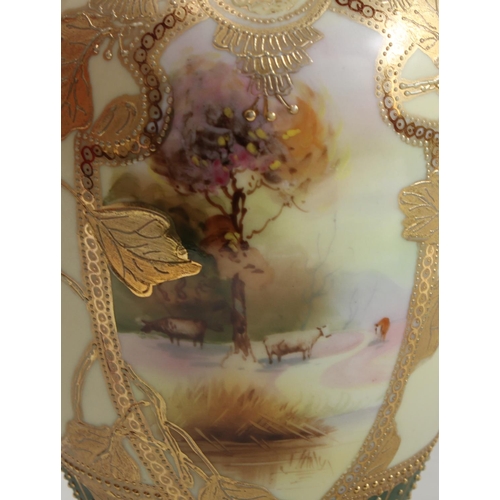 5126 - A pair of Noritake ovoid two handled vases, decorated with shield shped cartouches iwth cattle, the ... 