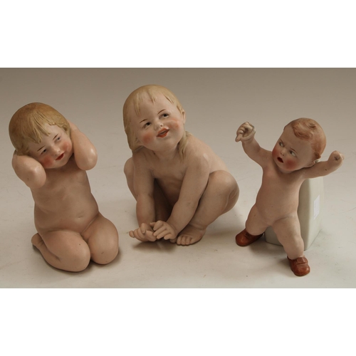 5127 - A Gebruder Heubach bisque piano baby, naked,  mischievous grin, 17cm, impressed mark; another simila... 