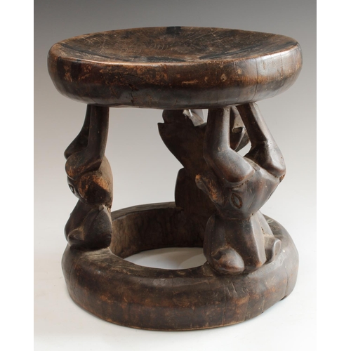 5134 - Tribal Art - a West African hardwood stool, possibly Kwele, Gabon, dished circular top, stylised ant... 