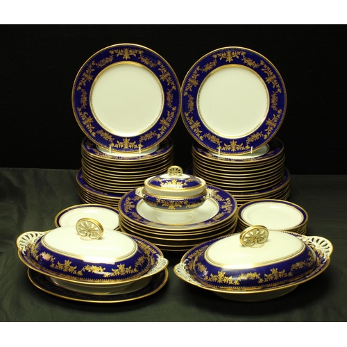 5142 - A late 19th/early 20th century Copeland's China part dinner service, gilt floral swags on cobalt blu... 