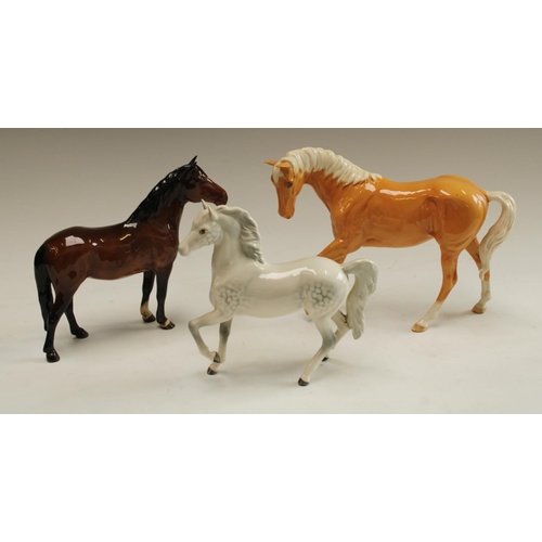 5166 - A Beswick horse model, New Forest; another, Dappled Grey Pony; Palamino horse (3)