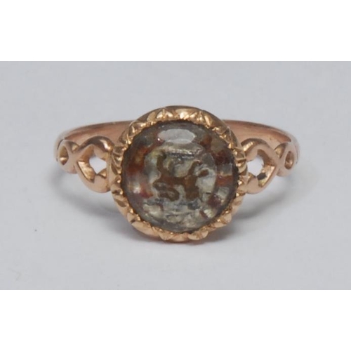 1025 - An 18th century carved rock crystal armorial signet ring, reverse carved crystal with painted Lion R... 