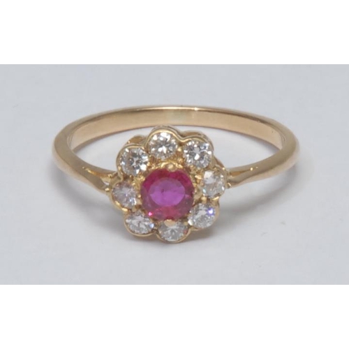 1028 - A ruby and diamond floral cluster ring, central vibrant red runy approx 0.25ct, surrounded by a coll... 