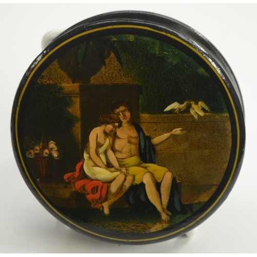 1133 - A 19th century papier-mâché circular table-top snuff box, the cover printed in colour with amorini i... 