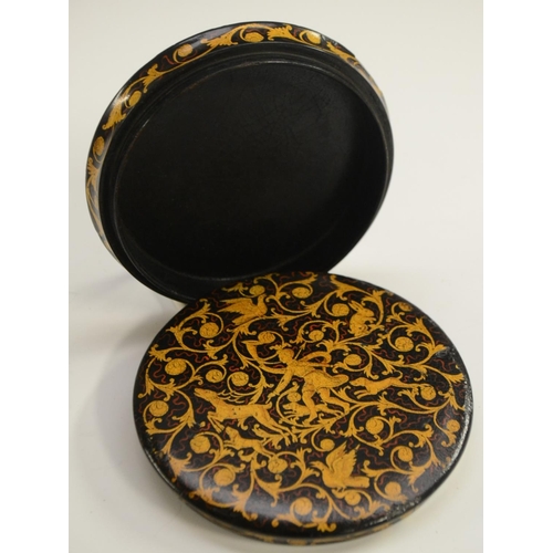 1135 - A 19th century Renaissance Revival black papier-mâché circular table-top snuff box, painted in gilt ... 