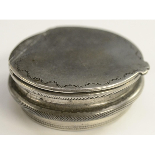 1145 - A late George III silver-mounted papier-mâché circular snuff box, the cover with an onset navette-sh... 