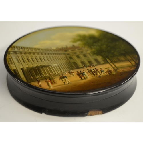 1153 - An early 19th century German Named-View papier-mâché circular table-top snuff box, by Stobwasser of ... 