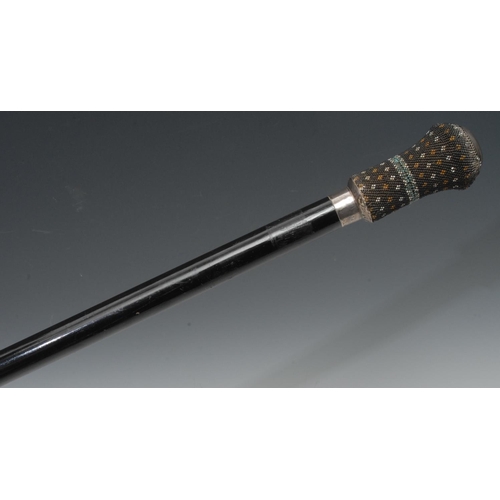 1180 - A Victorian walking cane, the beaded pommel with compartment and mirror, silver mounts, ebonised sha... 