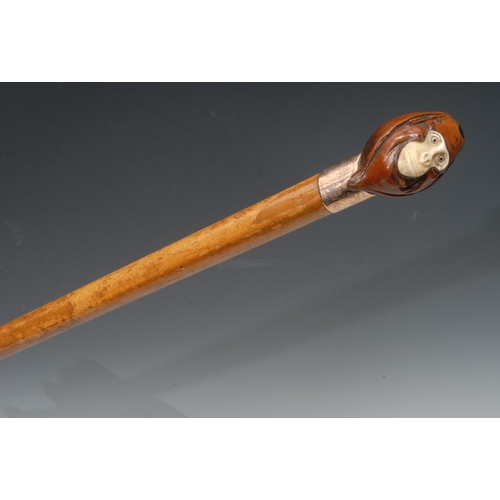 1184 - A late 19th/early 20th century walking cane, the coquila nut pommel carved as a monkey, ivory face, ... 