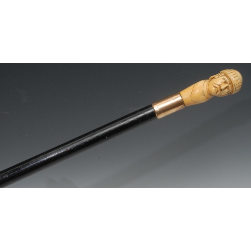 1196 - A late 19th century walking stick, the ivory handle carved with a Wagnerian man, gilt metal collar, ... 