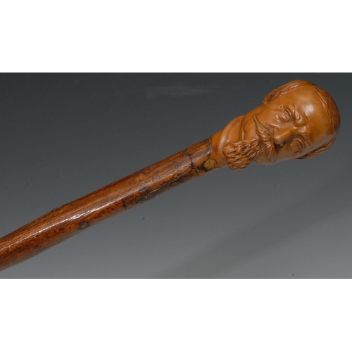 1200 - A 19th century Folk Art stick, carved with a Dickensian gentleman,  92.5cm long