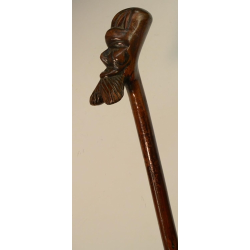 1207 - Folk Art - a 19th century novelty hedgerow walking stick, boldly carved with the head of a stylized ... 