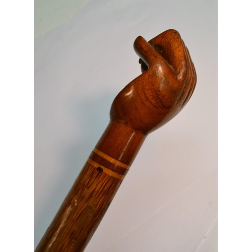 1236 - A South Seas novelty walking stick, the hardwood pommel carved as a fist and stamped Pitcairn Island... 