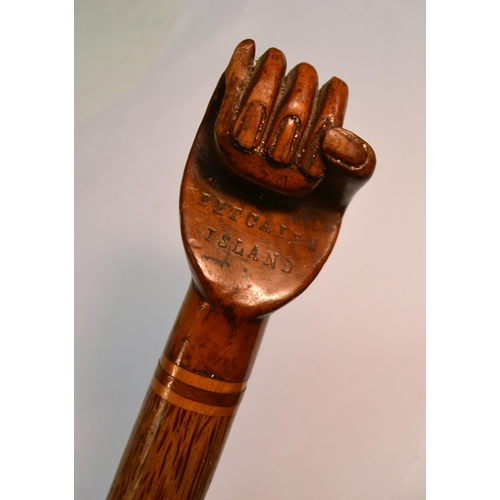 1236 - A South Seas novelty walking stick, the hardwood pommel carved as a fist and stamped Pitcairn Island... 