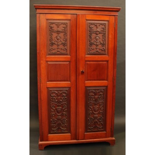 1290 - An Anglo-Indian hardwood hall cupboard, moulded cornice above a pair of rectangular doors, the panel... 