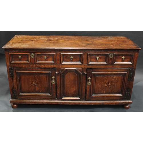 1291 - A '17th century' oak block front low dresser, three-plank top with applied moulded edge, above three... 