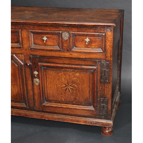 1291 - A '17th century' oak block front low dresser, three-plank top with applied moulded edge, above three... 