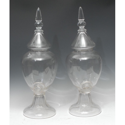 1308 - A pair of 19th century clear glass Chemist/apothecary jars, lofty cover, fluted bases, c.1890