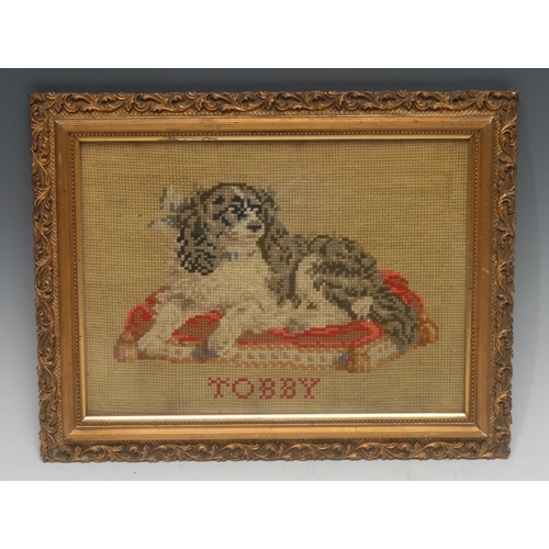 1309 - A 19th century Berlin woolwork picture, of a dog, Tobby (sic), the spaniel sits upon a cushion, 21.5... 