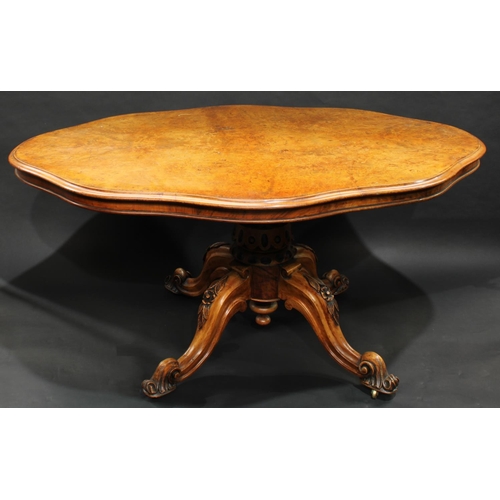 1311 - A Victorian walnut shaped oval breakfast table, moulded top with matched veneers, carved baluster co... 