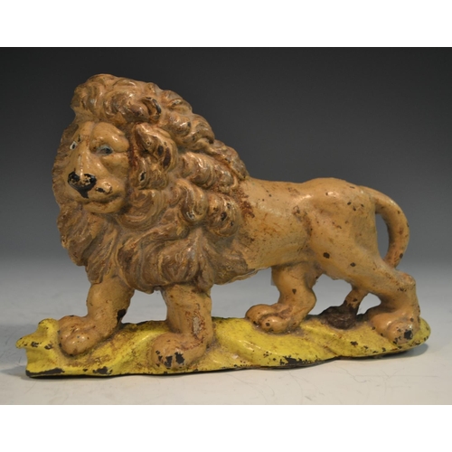 1318 - A 19th century cast iron novelty door stop, as a lion, painted in polychrome, 22.5cm wide, c.1850