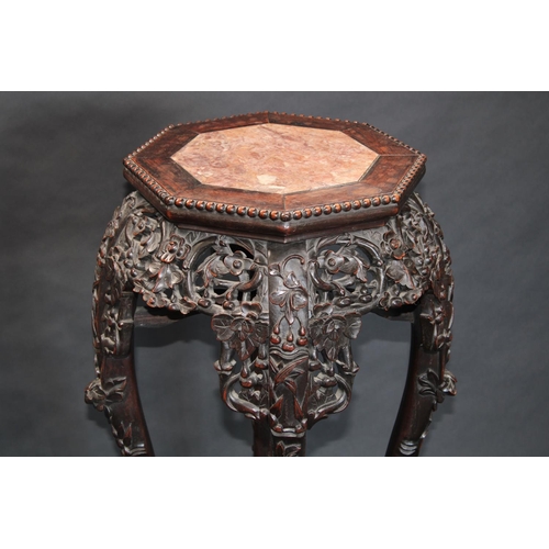 1323 - A 19th century Chinese hardwood jardiniere stand, octagonal top with inset soapstone panel, beaded b... 