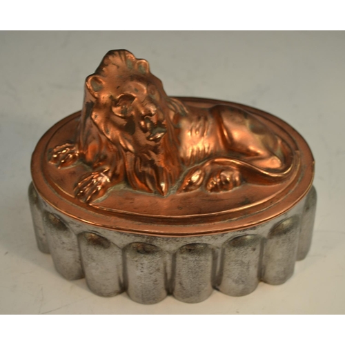 1329 - A 19th century copper and tin novelty jelly mould, as a recumbent lion, 18cm long