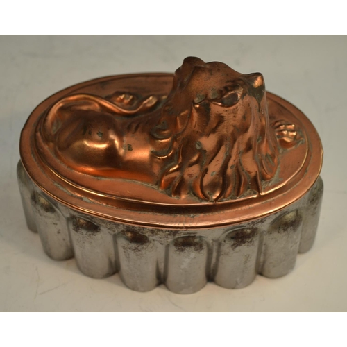 1329 - A 19th century copper and tin novelty jelly mould, as a recumbent lion, 18cm long