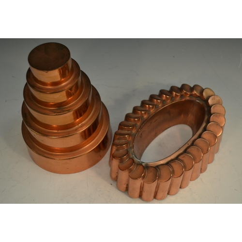 1330 - A 19th century copper fluted oval 'ring' jelly mould, 21cm wide; a 19th century circular graduated '... 