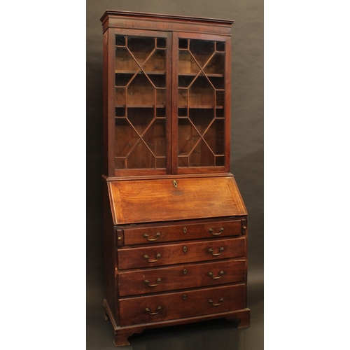 1331 - A George II/early George II mahogany bureau bookcase, moulded cornice above a pair of astragal glaze... 