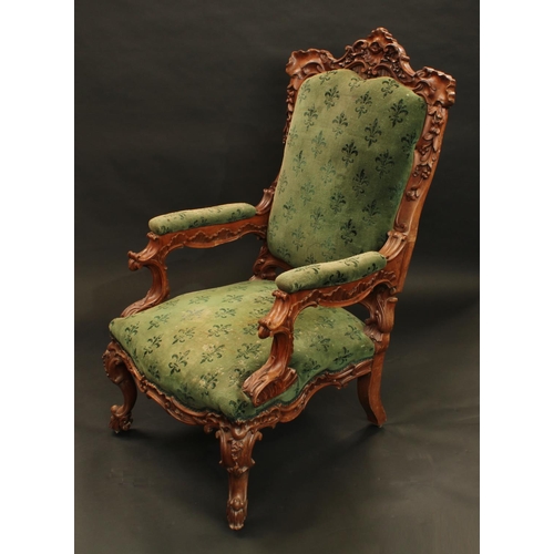 1348 - A 19th century Anglo-Indian solid satinwood armchair, boldly carved througout with flowers and leafy... 