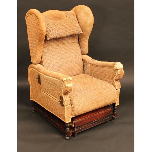 1377 - A 19th century mahogany patent reclining wingback armchair, adjustable back and hinged arms, above a... 