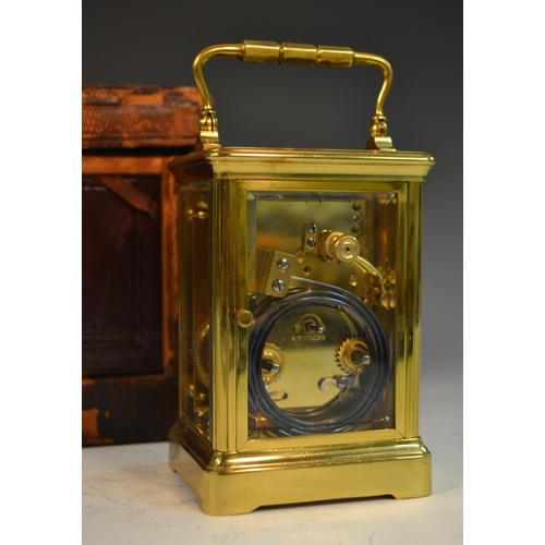 1390 - A 19th century repeater carriage clock, with Roman numerals, bevelled glass panels, swing handle, 19... 