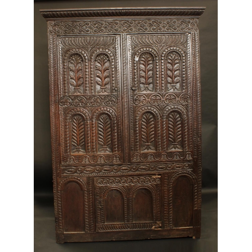 1396 - A '17th century' oak hall cupboard, fluted oversailing cornice above a pair of panel doors above a f... 